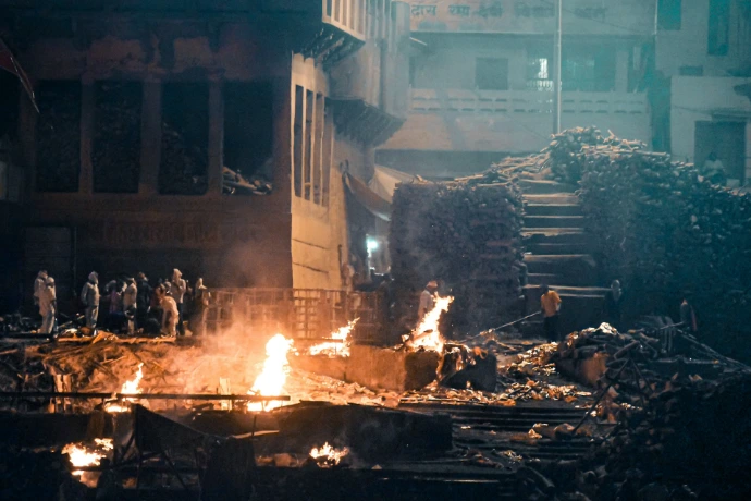 A group of people standing around a fire pit